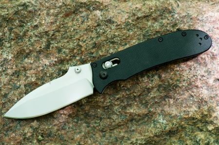 Knife is folding on a background a graniteの写真素材