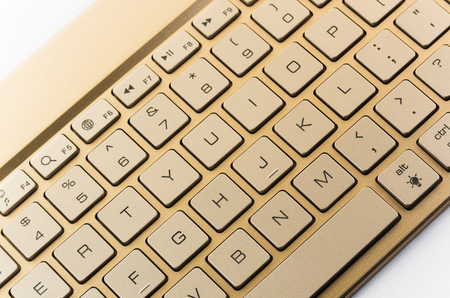 Gold keyboard on a white backgroundの写真素材