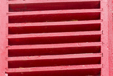 Old wooden shutters in red colorの写真素材