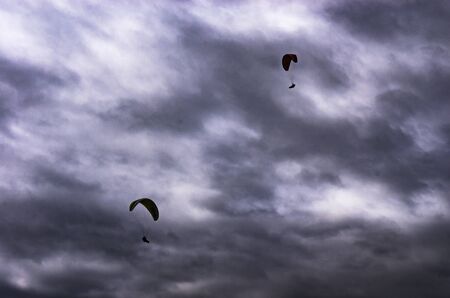 Paraglider on a background of cloudy skyの写真素材