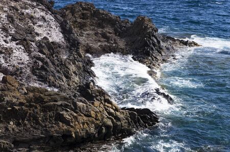 Coastal cliffs in the sea surf, landscapeの写真素材