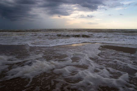 Foam on the shore of a stormy sea, landscapeの写真素材