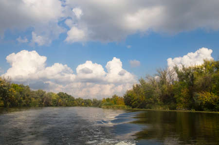 Autumn landscape on the river with trees on the bankの写真素材