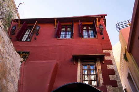 Old red building on a narrow street, Creteの写真素材