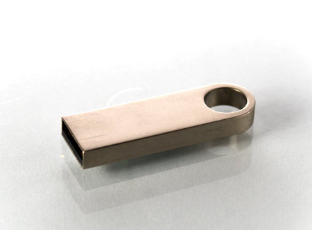 One metal flash drive on a white backgroundの写真素材