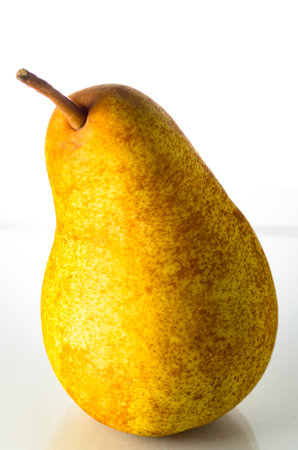 One yellow pear on a white backgroundの写真素材