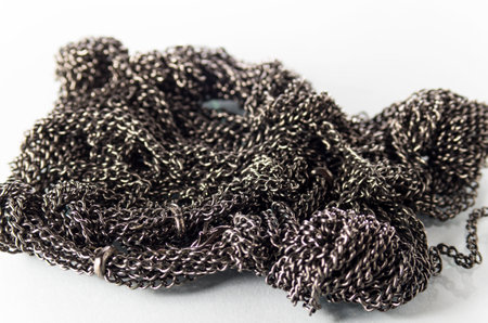 Lots of metal chains on a white backgroundの写真素材