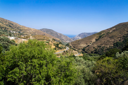 Winding mountain road leading to the seashoreの写真素材