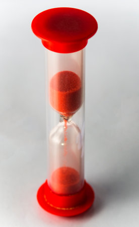 One red hourglass on a white backgroundの写真素材