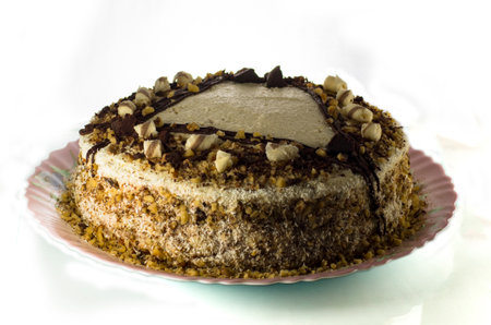 Brown mousse cake on a plate on a white backgroundの写真素材