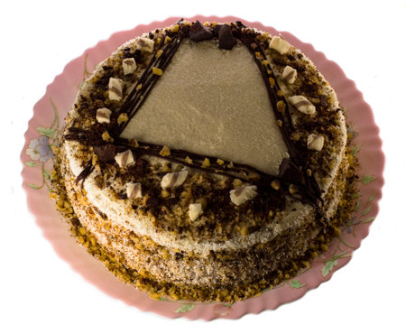 Brown mousse cake on a plate on a white backgroundの写真素材