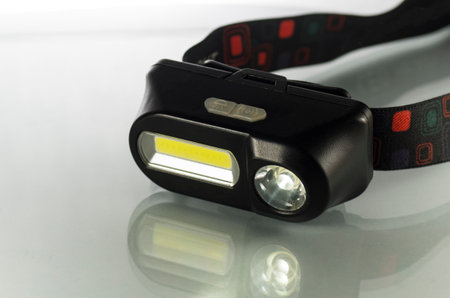 Black headlamp on a white background, close-upの写真素材