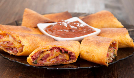 Mexican tortillas with cheese, smoked sausage and gravy.の写真素材