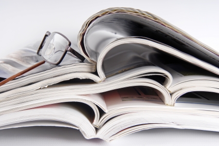 stack of magazine and glassesの写真素材