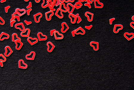 red heart confetti on black backgroundの写真素材