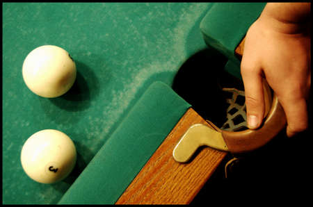Billiard balls lie on the table near the pocketの写真素材