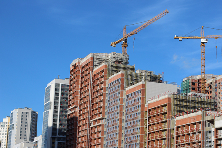 Inside place for many tall buildings under construction and cranes.の写真素材