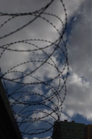 Background. Beautiful Blue Sky With Clouds behind the barbed wireの写真素材