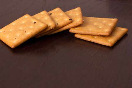 cookies crackers on a dark wooden backgroundの写真素材