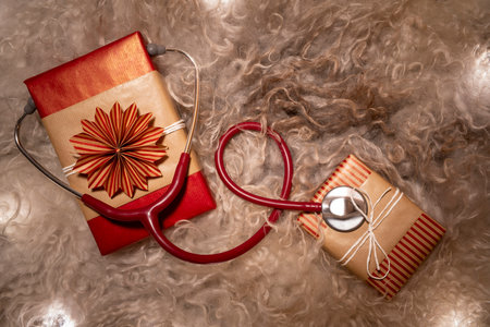 Merry Christmas handmade Gift Boxes with Stethoscope on Christmas Flat Lay. Use for Christmas or Happy Holiday Greeting Card to show appreciation to Healthcare workers.の写真素材