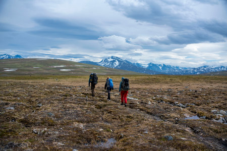 Padjelanta National Park, Beautiful Mountain Scenery and Hiking Trails leading away from Camera with group of hikers trekking and living the wanderlust dream.の写真素材