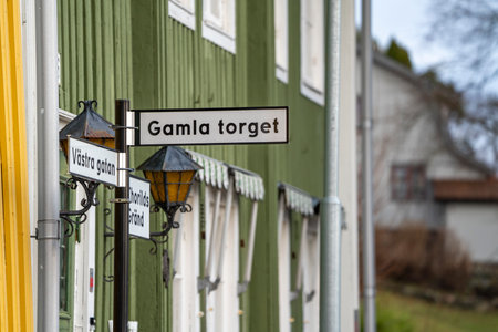 A pole, with city or street names and directions, placed on Old Square Street in Kungalv City, Swedenの写真素材