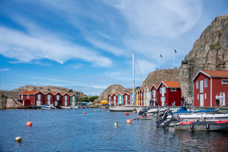 Smogen, Sweden - July 2020: Famous Coastal Town of Smogen on the West Coast of Sweden with Colorful Boat houses and lively piers and Ferry Departures.のeditorial素材