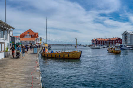 Smogen, Sweden - July 2020: Famous Coastal Town of Smogen on the West Coast of Sweden with Colorful Boat houses and lively piers and Ferry Departures.のeditorial素材