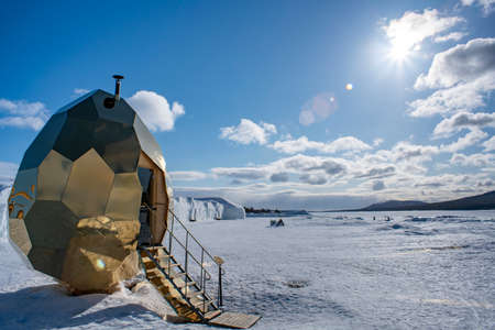 Jukkasjarvi, Sweden - 2020: Golden Egg Sauna in Jukkasjarvi Icehotel Late Winter on a sunny day, Lapland Sweden. The famous Sauna has visited several other cities around the world.のeditorial素材