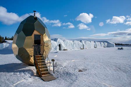 Jukkasjarvi, Sweden - 2020: Golden Egg Sauna in Jukkasjarvi Icehotel Late Winter on a sunny day, Lapland Sweden. The famous Sauna has visited several other cities around the world.のeditorial素材