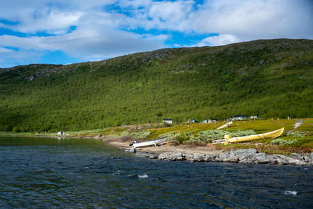 Beautiful Coastline of Virihaure Lake in Staloluokta Same Village and Mountain Station In Padjelanta National Park With Colorful Boats Stranded on the Beach used for Fishing and Transportation.のeditorial素材