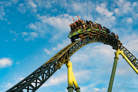 GOTHENBURG, SWEDEN - JULY 8, 2019: People screaming and holding up hands during roller coaster ride Helix at Liseberg amusement park Gothenburg Sweden - People having fun at their leisure.のeditorial素材
