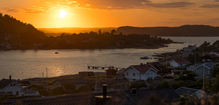 Setting sun over Archipelago of Rortangen and big island Bratton Sweden - Low sun casts light over reflecting sea and valley.の写真素材