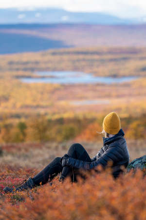 Caucasian outdoor active woman sitting In beautiful Autumn Colorsの写真素材