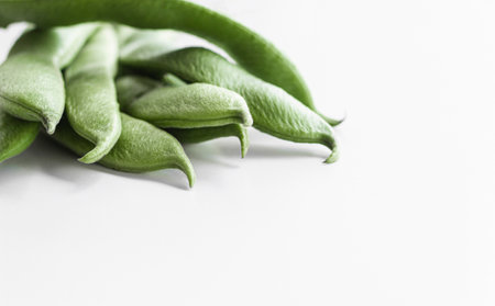 Green bean pods, located on the left. Space for text.の写真素材