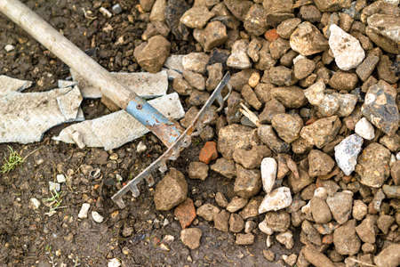 A rake for leveling rubble. Building materials. Concept: construction, road repairs, sale of crushed...