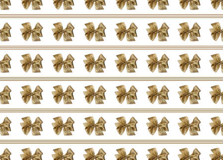 Gold bows for decorating gifts on a white background. Beautifully tied bow with stripes. Photo of a gift package with a seamless pattern.の写真素材