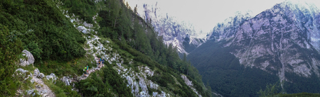 Mountain path in the Julian Alps with hikers having a break on the long way up to Triglav summit, Slovenia, July 2016.のeditorial素材