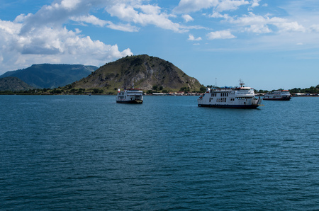 Three ferry boats waiting in front the harbour of Sumbawa island in Indonesia, March 2017.のeditorial素材