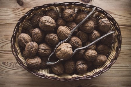 Walnuts with nutcracker in a bowl.の写真素材