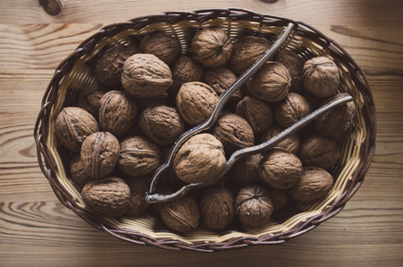 Bowl of walnuts with nutcracker.の写真素材