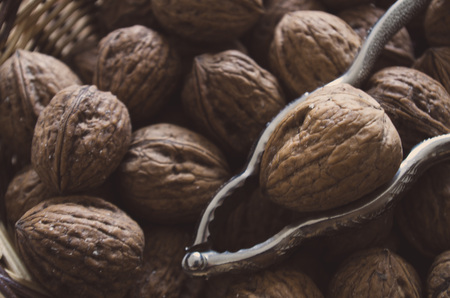 Close-up: Walnuts with nutcracker in a bowl.の写真素材