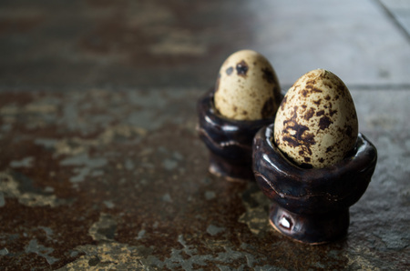 Two quail eggs on table next to each other with copy space on the right.の写真素材