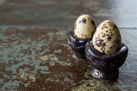 Two quail eggs on table next to each other with copy spaceの写真素材