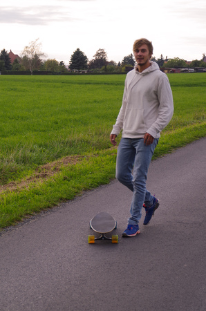 Young man with longboard taking a break.の写真素材