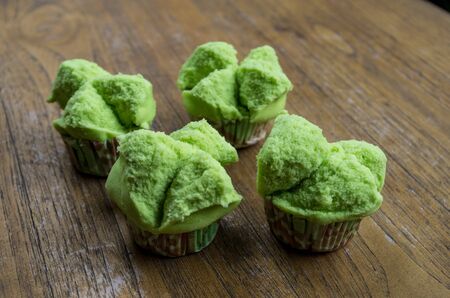 Typical Indonesian sweets green bolu kukus on table next to each other.の写真素材