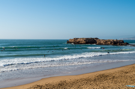 People surfing the waves at surf spot called Devils Rock near Tamraght in Morocco, January 2018.の写真素材