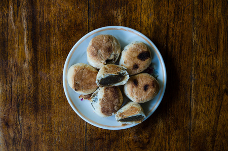 Typical Indonesian sweets: Bakpia centered on plate from birds eye perspective.の写真素材