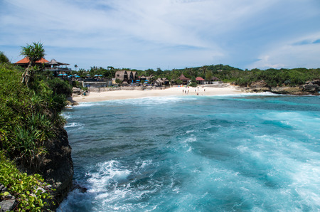 Tourists enjoy a beautiful bathing day at Dream Beach on Nusa Lembongan, Indonesia, February 2017.の写真素材