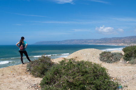 Woman looking at the coastline from Killer Point surf spot.の写真素材